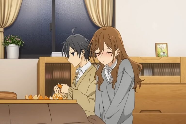 Izumi Miyamura peeling oranges while Kyouko Hori blushes and sits beside him in a scene from the anime Horimiya.